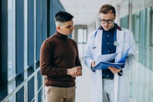 Doctor talking with his patient at clinic